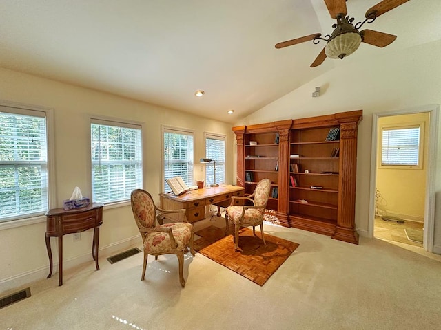 living area featuring ceiling fan, light carpet, and vaulted ceiling