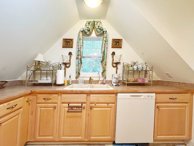 kitchen with white dishwasher, sink, light brown cabinets, and lofted ceiling