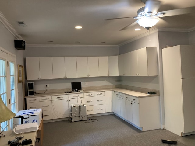 kitchen featuring ceiling fan, white cabinets, crown molding, and white fridge