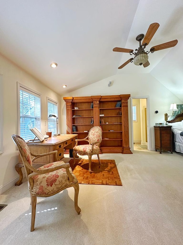 living area featuring light carpet, ceiling fan, and lofted ceiling