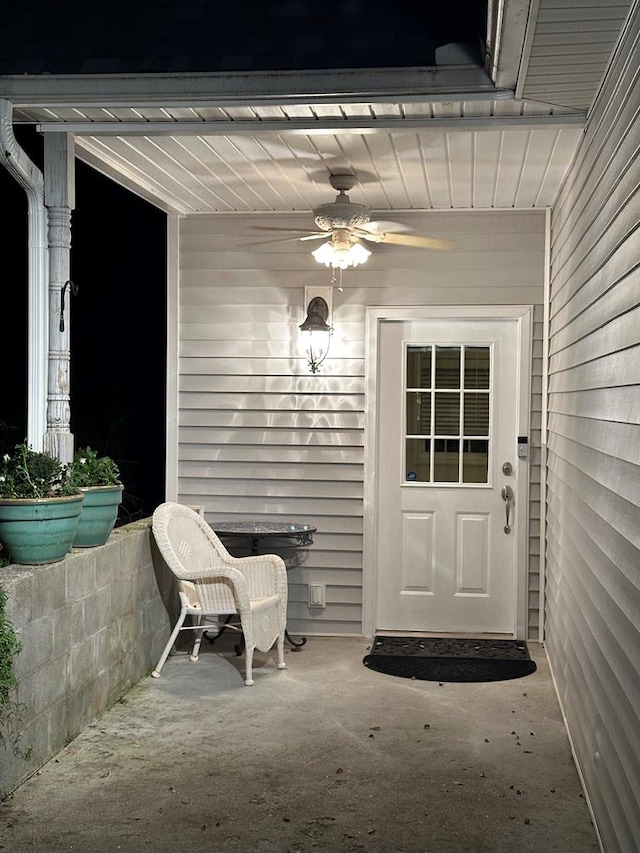 view of exterior entry with ceiling fan