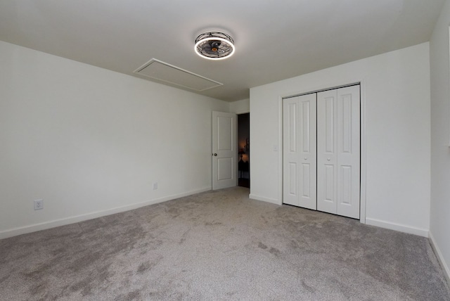 unfurnished bedroom featuring light carpet and a closet