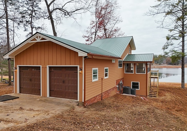 garage featuring cooling unit and a water view