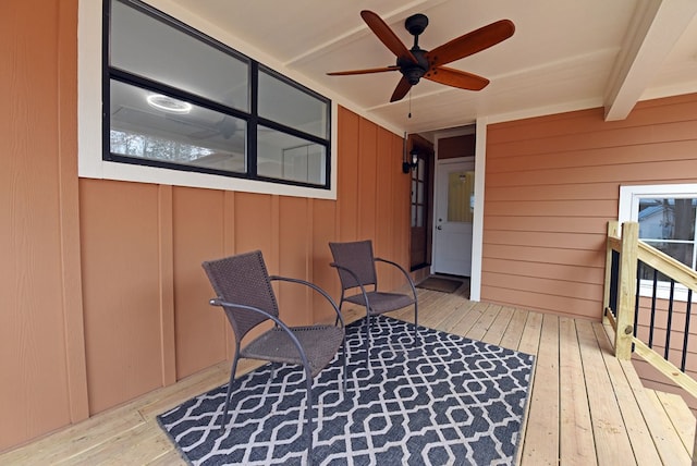 wooden terrace featuring a ceiling fan