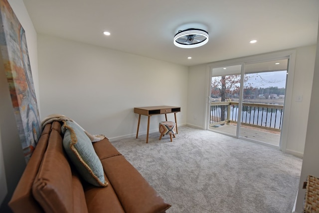 living area featuring carpet floors, recessed lighting, a water view, and baseboards