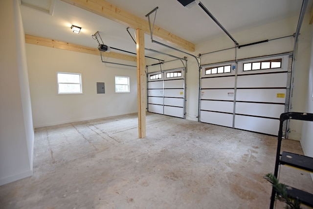 garage featuring a garage door opener, electric panel, and baseboards