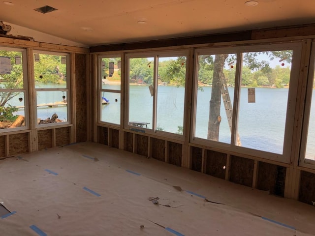 unfurnished sunroom featuring a water view and lofted ceiling