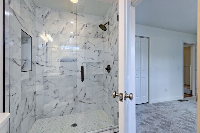 bathroom featuring a stall shower, visible vents, and baseboards