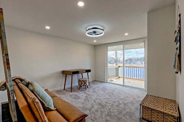 living area featuring carpet floors, a water view, baseboards, and recessed lighting