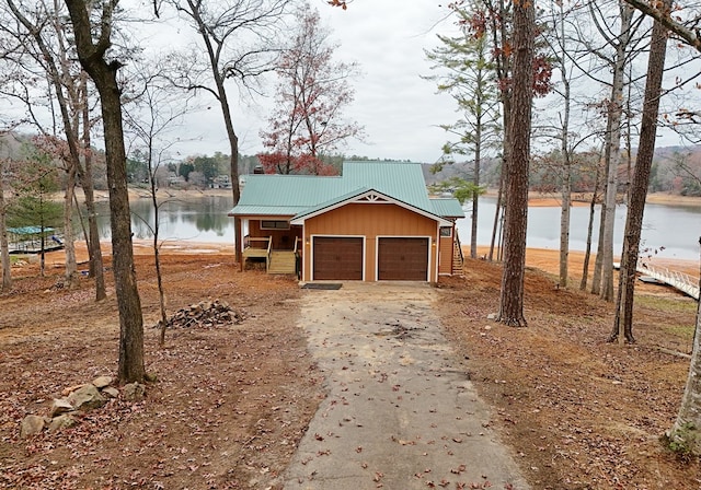 exterior space with a garage and a water view