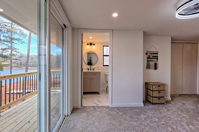 carpeted bedroom with baseboards, connected bathroom, access to outside, a sink, and recessed lighting