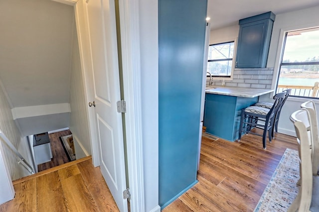 interior space featuring light wood-style floors, a sink, and recessed lighting