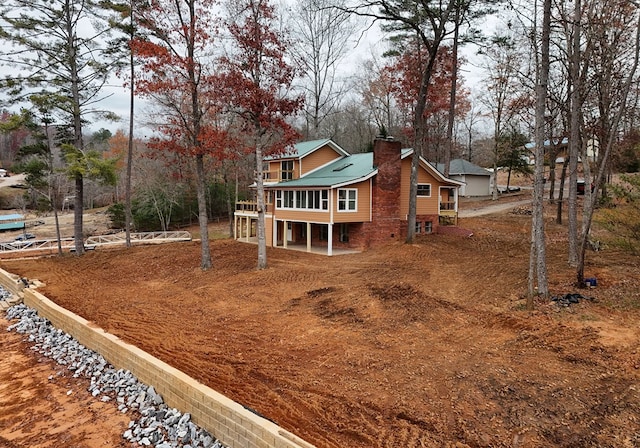 exterior space with a chimney and metal roof