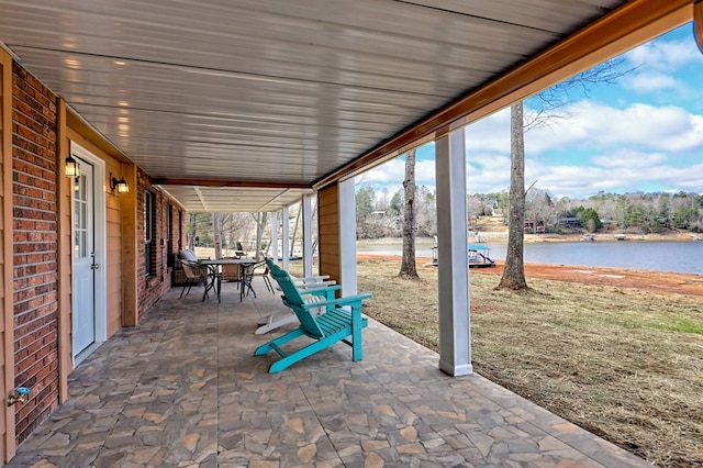 view of patio / terrace featuring outdoor dining space and a water view