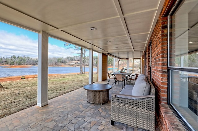 view of patio / terrace featuring a water view and outdoor dining space