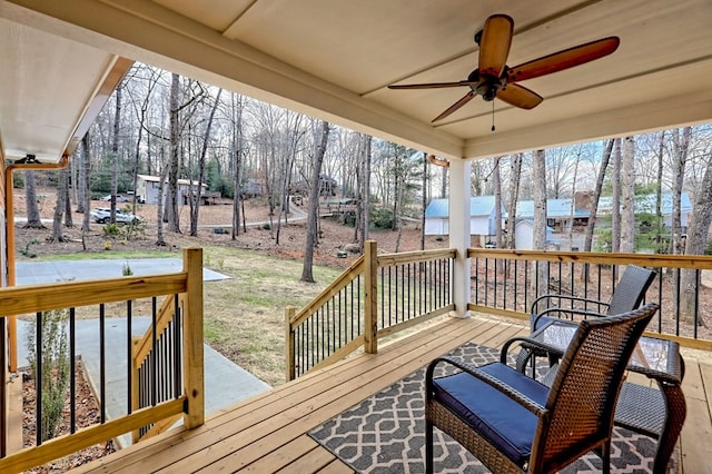 wooden deck featuring a ceiling fan