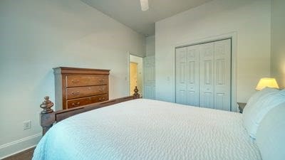 bedroom with ceiling fan and a closet