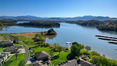 birds eye view of property with a water and mountain view