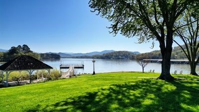 view of yard featuring a dock and a water and mountain view