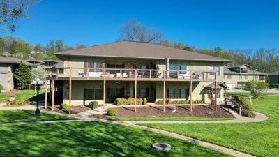 rear view of property featuring a lawn