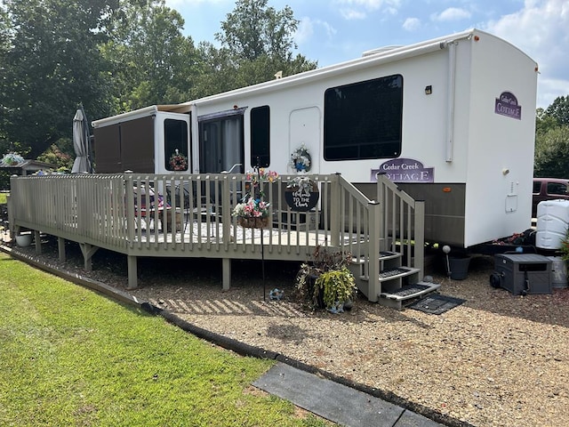 rear view of property featuring a wooden deck