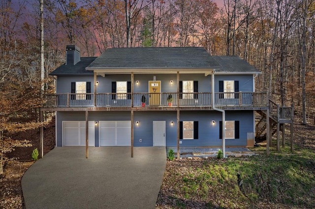 view of front of property featuring a deck and a garage