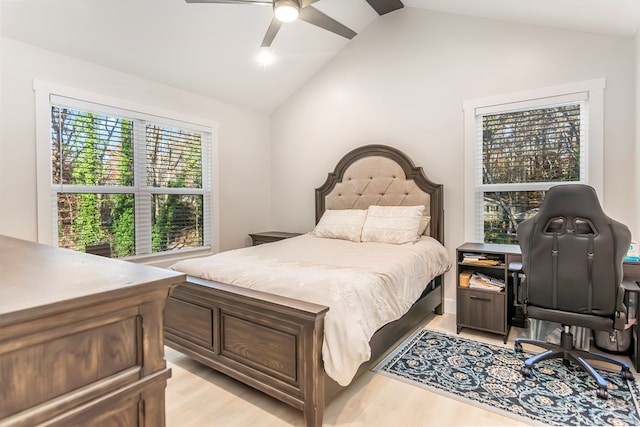 bedroom with ceiling fan, lofted ceiling, and light hardwood / wood-style flooring