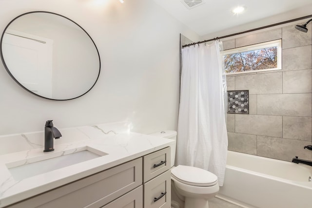 full bathroom featuring toilet, vanity, and shower / tub combo