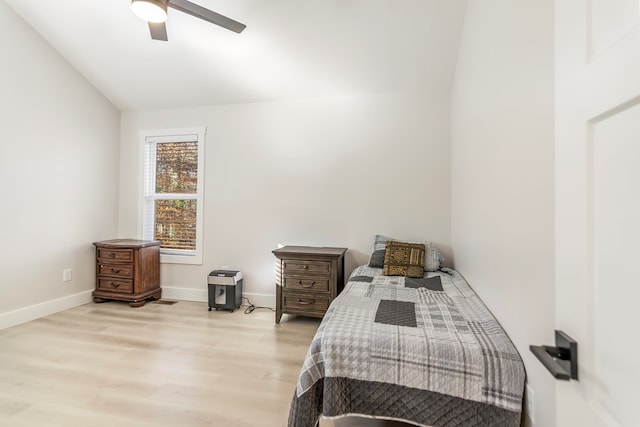 bedroom featuring ceiling fan, vaulted ceiling, and light hardwood / wood-style flooring