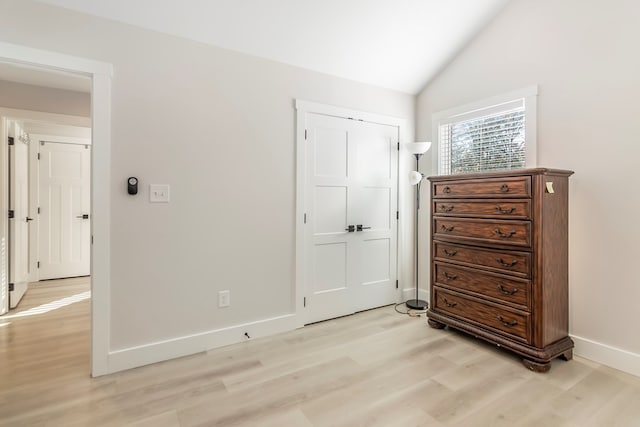 bedroom with light hardwood / wood-style flooring and vaulted ceiling