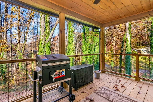 sunroom / solarium with ceiling fan and wood ceiling