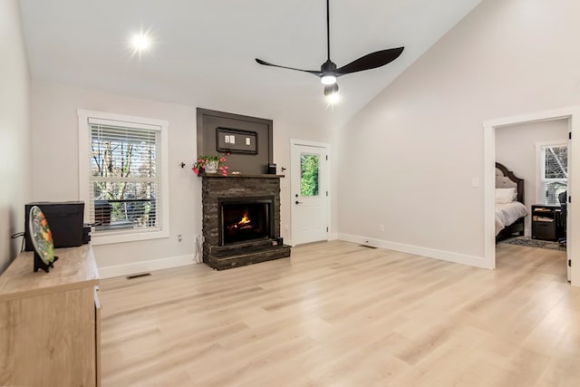 living room featuring ceiling fan, light wood-type flooring, and high vaulted ceiling