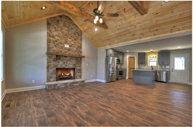 unfurnished living room featuring a stone fireplace, dark wood-type flooring, wooden ceiling, and ceiling fan