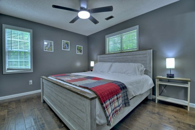 151 Padget Ln, Ellijay, GA 30540 - bedroom with hardwood / wood-style floors, multiple windows, baseboards, ceiling fan, and a textured ceiling