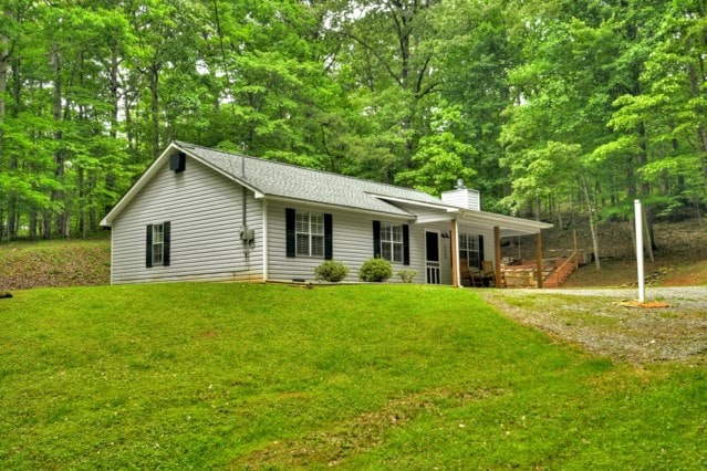 151 Padget Ln, Ellijay, GA 30540 - ranch-style house with covered porch, a chimney, a front lawn, and a shingled roof