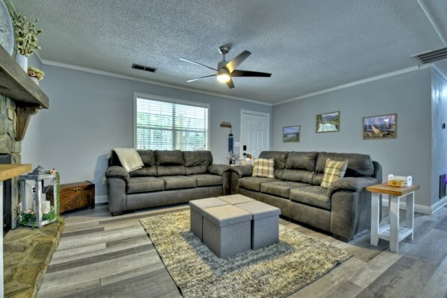151 Padget Ln, Ellijay, GA 30540 - living area with a ceiling fan, crown molding, a textured ceiling, light wood-style floors, and baseboards
