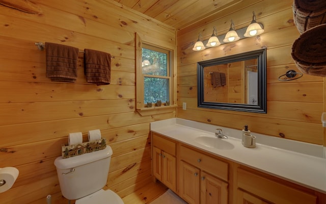 bathroom featuring vanity, toilet, wood ceiling, and wood walls