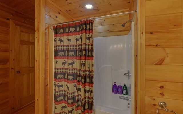 bathroom with shower / bathtub combination with curtain, wood ceiling, and wooden walls