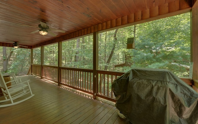 unfurnished sunroom featuring ceiling fan and wood ceiling