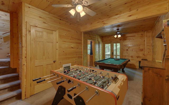 game room featuring ceiling fan, light colored carpet, and wooden walls