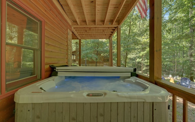 wooden terrace featuring a hot tub