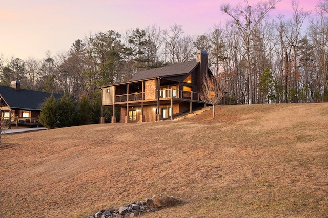 exterior space featuring a wooden deck and a chimney