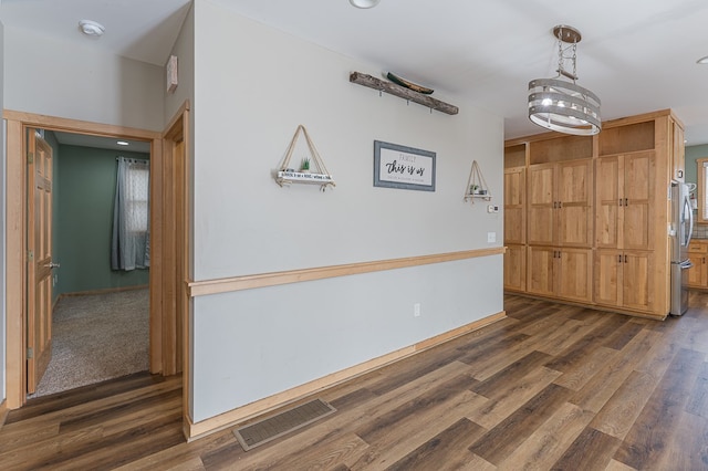 interior space featuring dark wood-type flooring and a notable chandelier