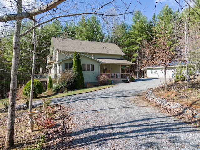 view of front of property with an outbuilding, a garage, and covered porch