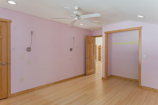 empty room featuring ceiling fan, vaulted ceiling, and light hardwood / wood-style floors