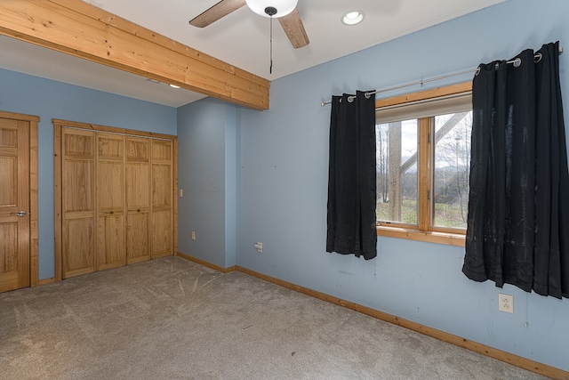 unfurnished bedroom featuring light colored carpet and ceiling fan