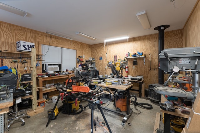 garage with wood walls and a workshop area