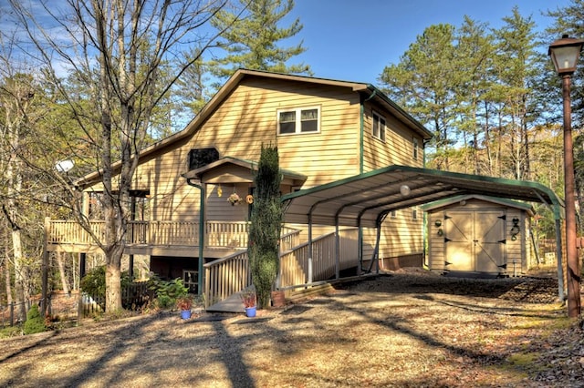 view of side of home with a carport and a storage shed