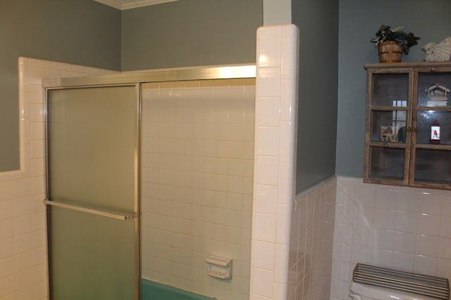 bathroom featuring ornamental molding, tile walls, and toilet