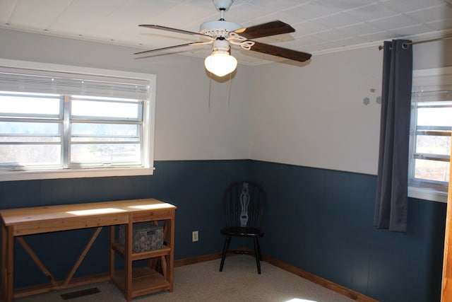 interior space featuring carpet floors and ceiling fan